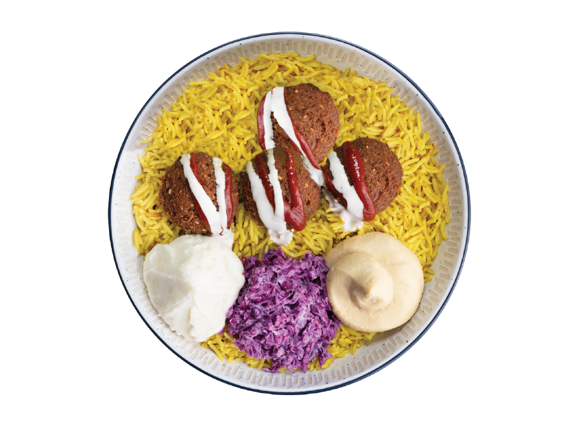 Falafel served over basmati rice with turnips, hummus, tahini, parsley, tomatoes and lettuce